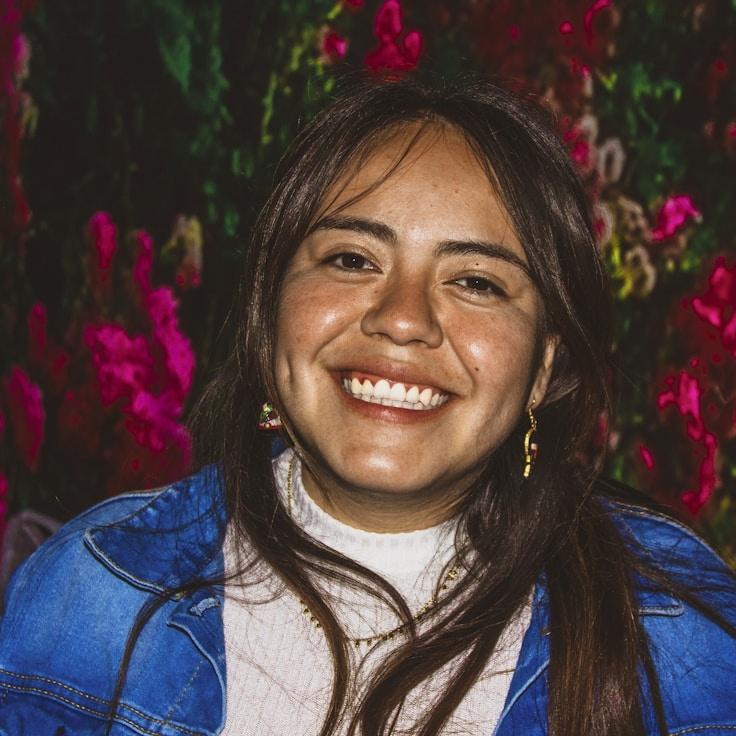 Amara Singh, Lead Design Curator at OrchardPulseWell, reviewing corporate floral arrangements